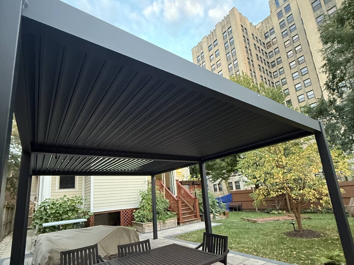 black pergola installed in backyard
