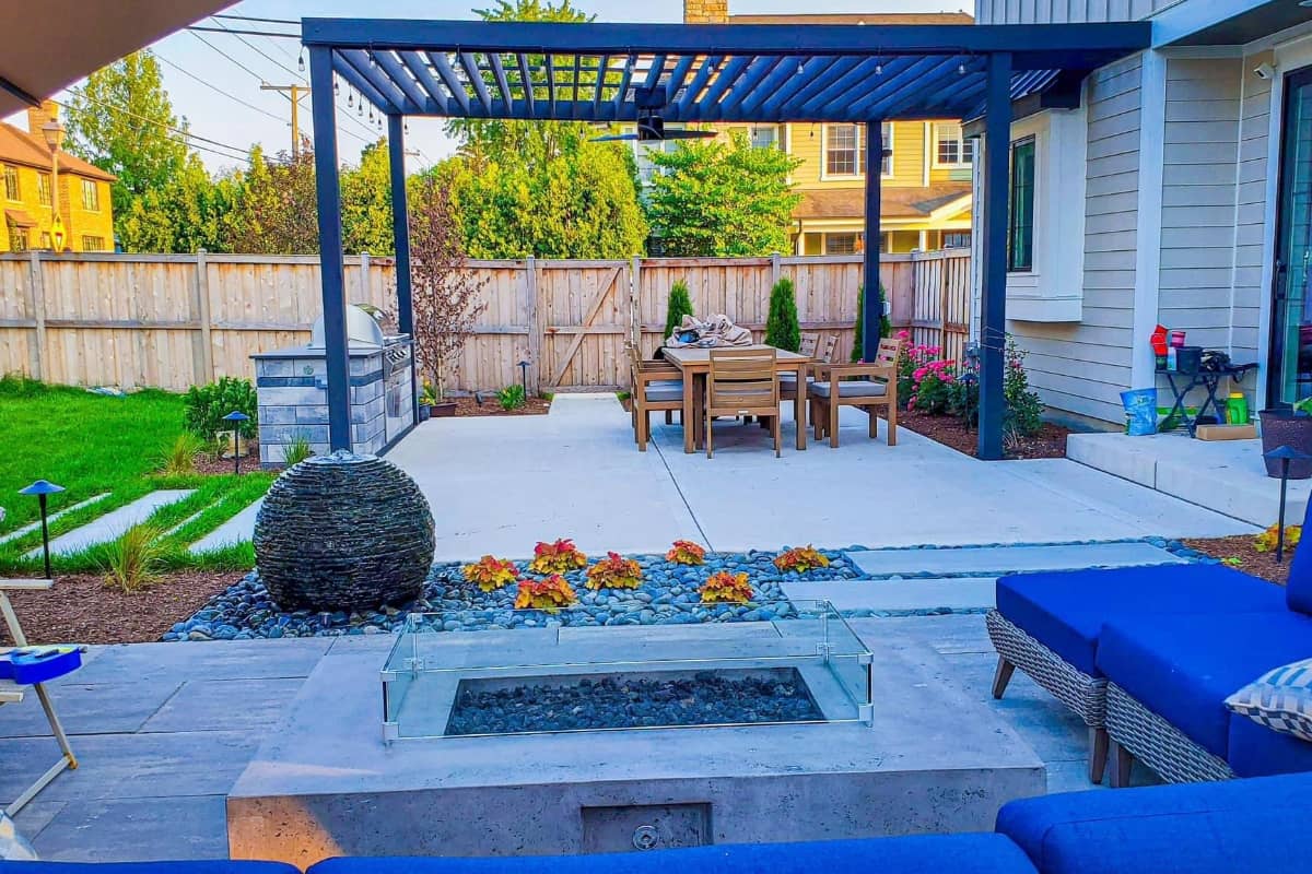 a new hardscape patio with pergola and water features