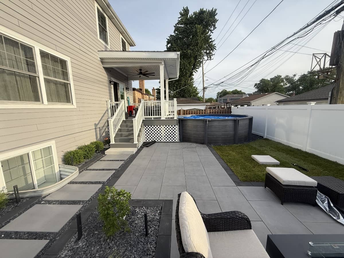 paver patio installed around swimming pool and turf replacement for the backyard