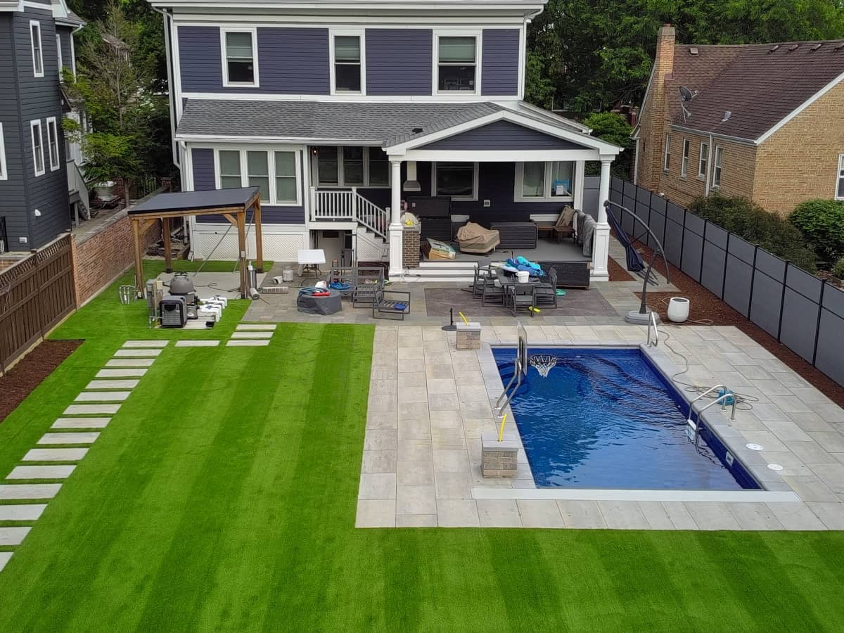 luxury paver and turf residential installation with hardscape around pool