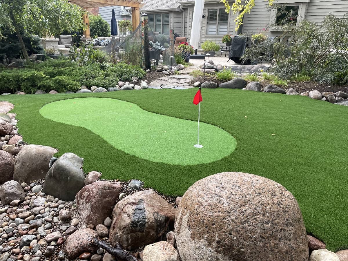 turf installation with mini golf in backyard