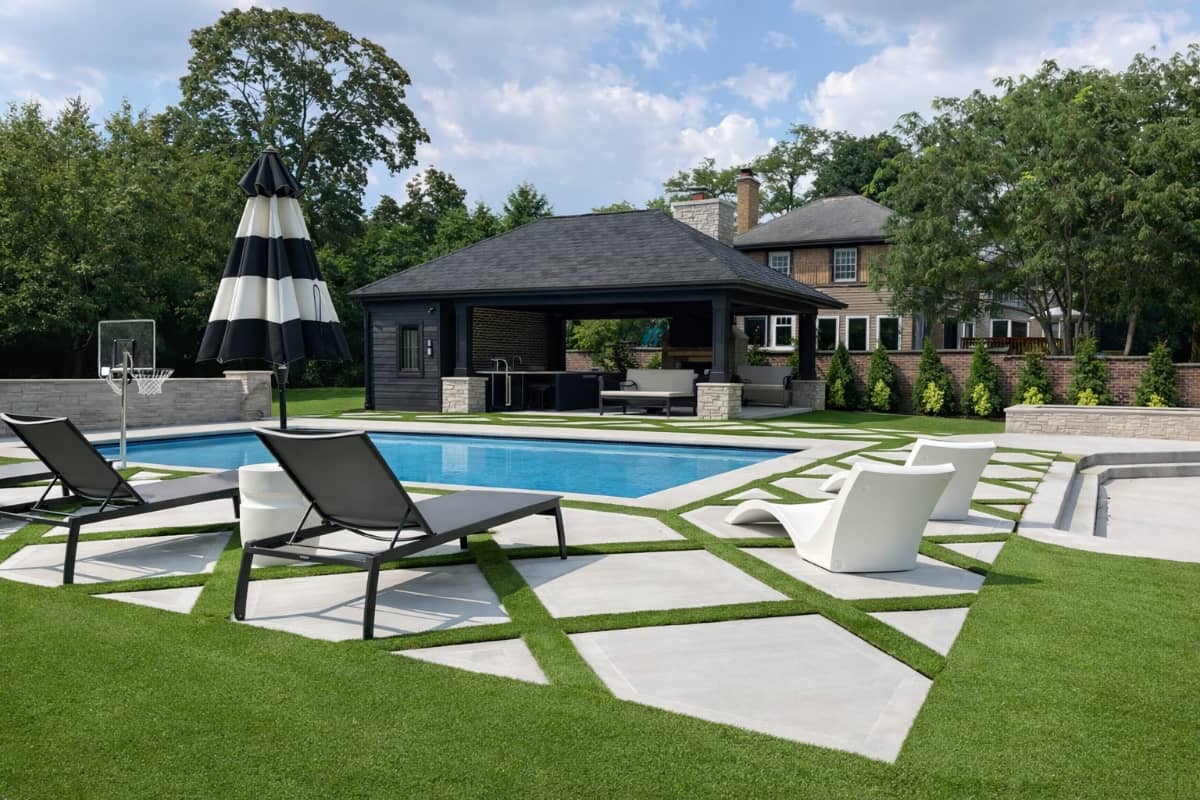 turf install with a luxurious pool in the backyard